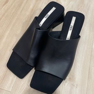 Slightly worn beautiful black leather mules